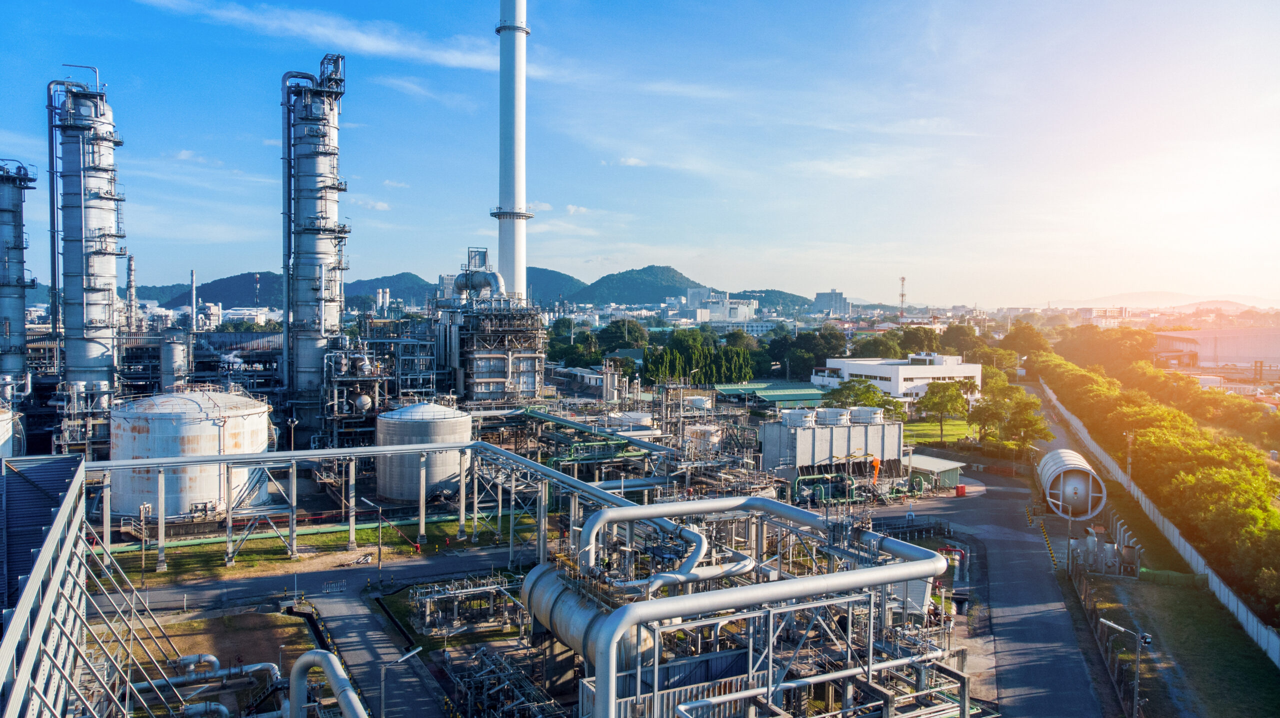 Aerial view of chemical oil refinery plant, power plant on blue sky background.